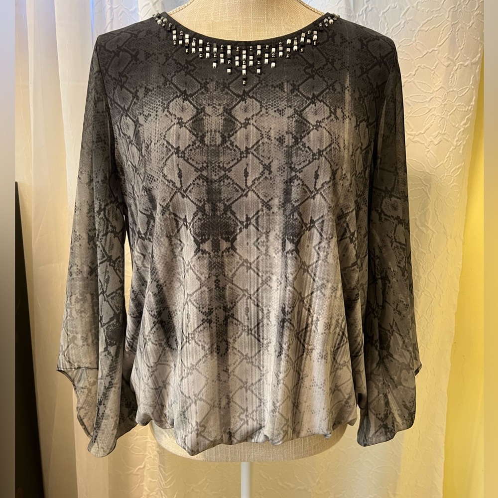 Alfani PL women’s blouse with embellishments along neckline.